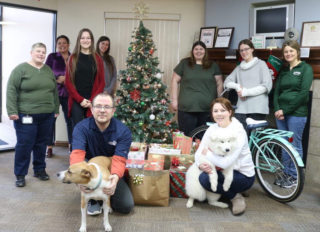 Representatives of Carnivore Meat Company beside gifts for a special veteran family.